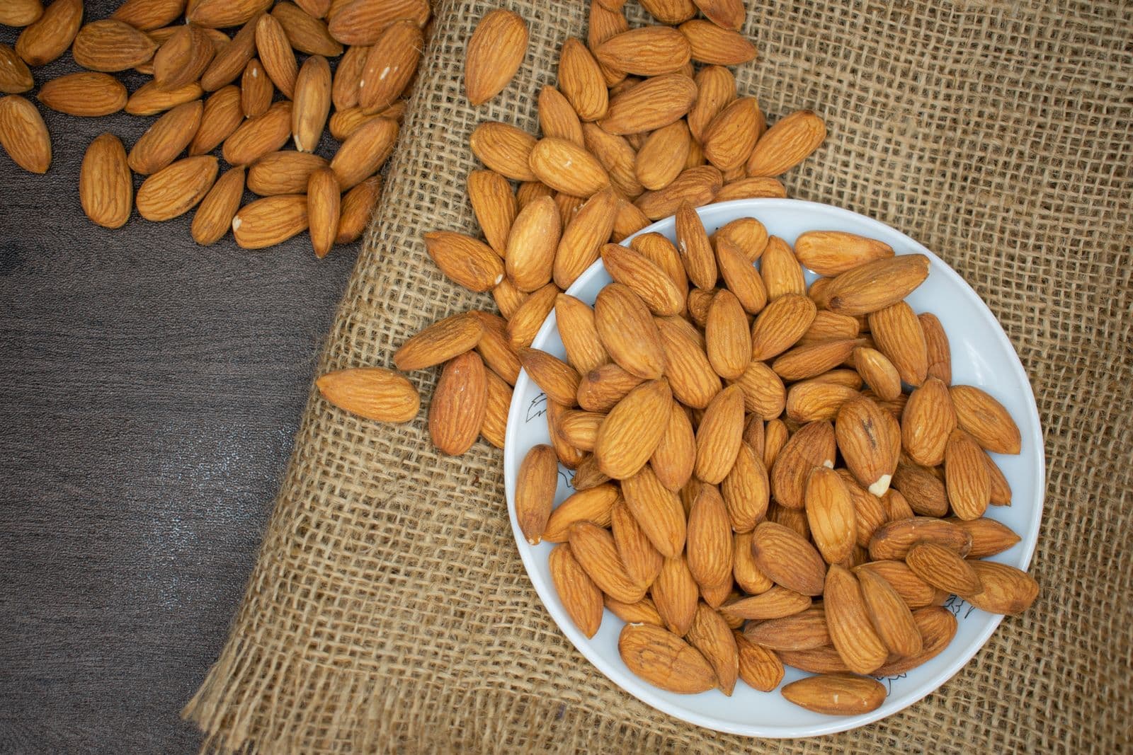 Premium Kashmiri almonds in a wooden bowl