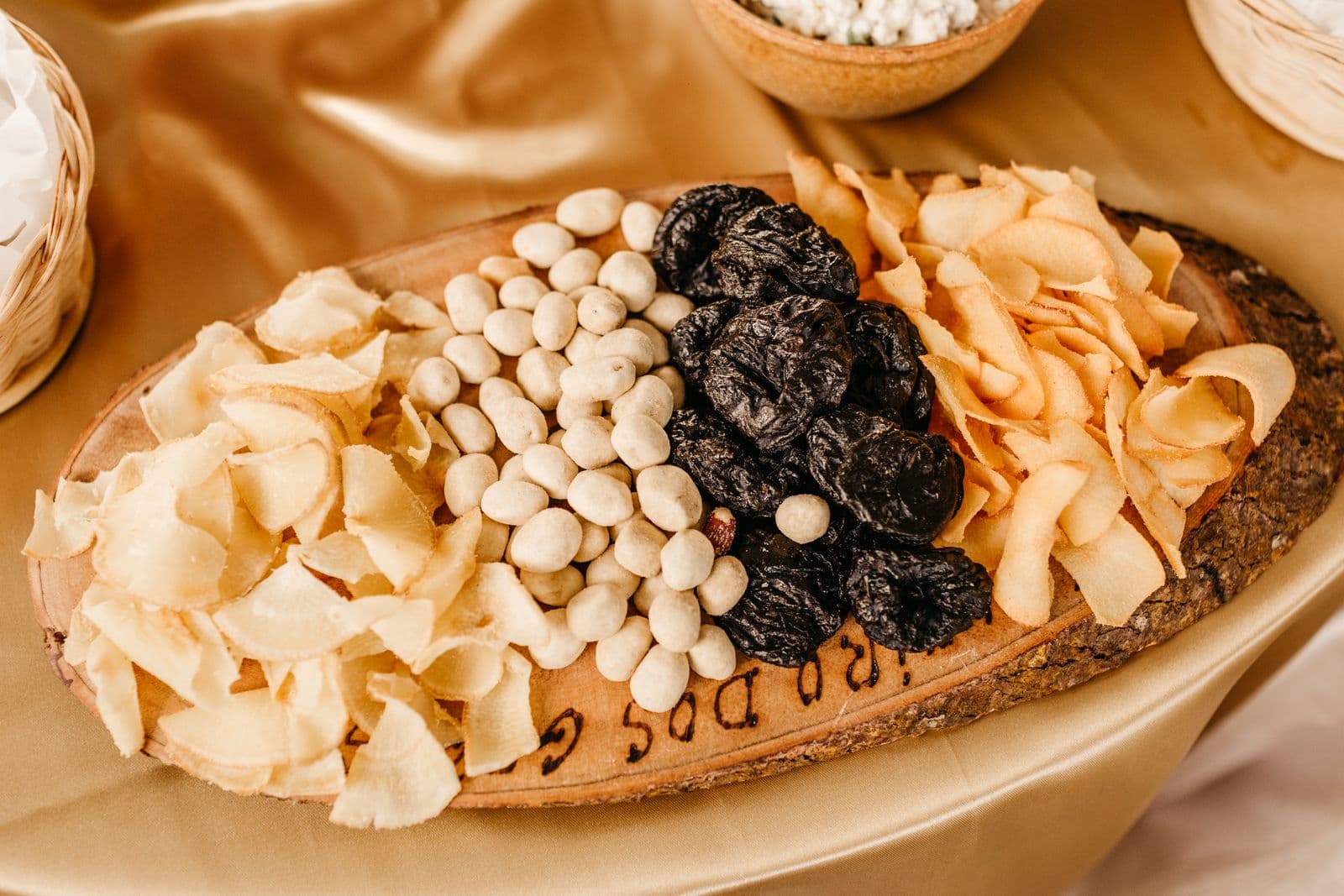 Assorted dried fruits on a rustic wooden platter