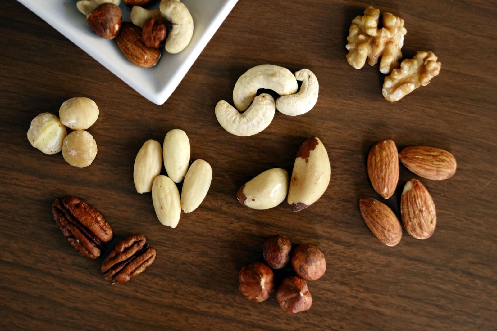 Walnuts and mixed nuts on a wooden table
